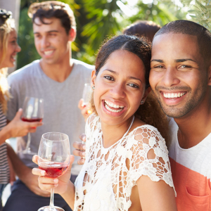 smiling couple holding wine