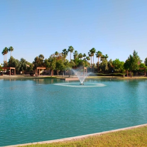 The Lake at Summit lake with picnic areas, palm trees and blue skies in the background