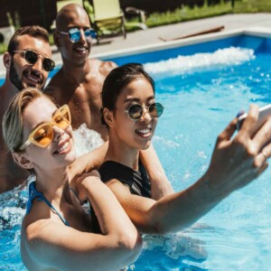 friends taking selfie in pool