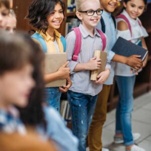 kids holding books smiling